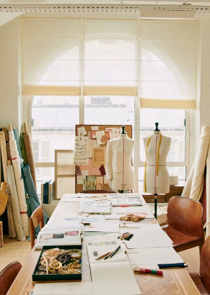 Design studio workspace with dress forms and fabric rolls