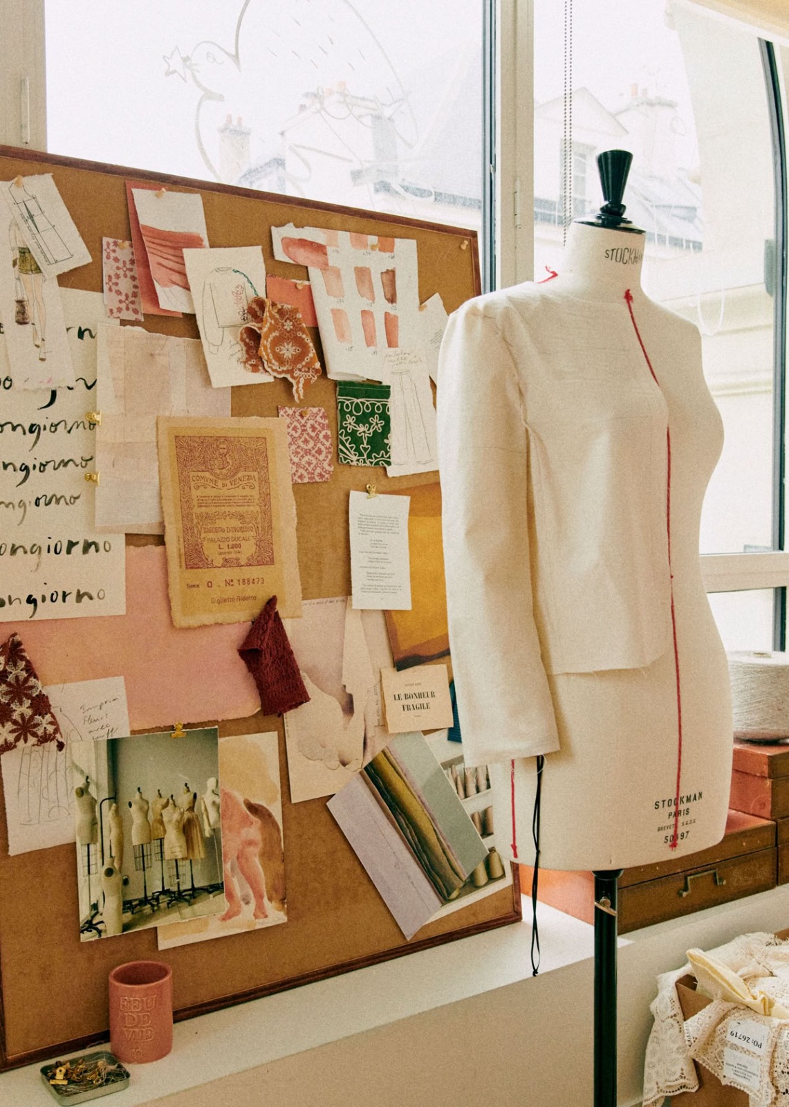 Fashion design studio with mood board and dress form